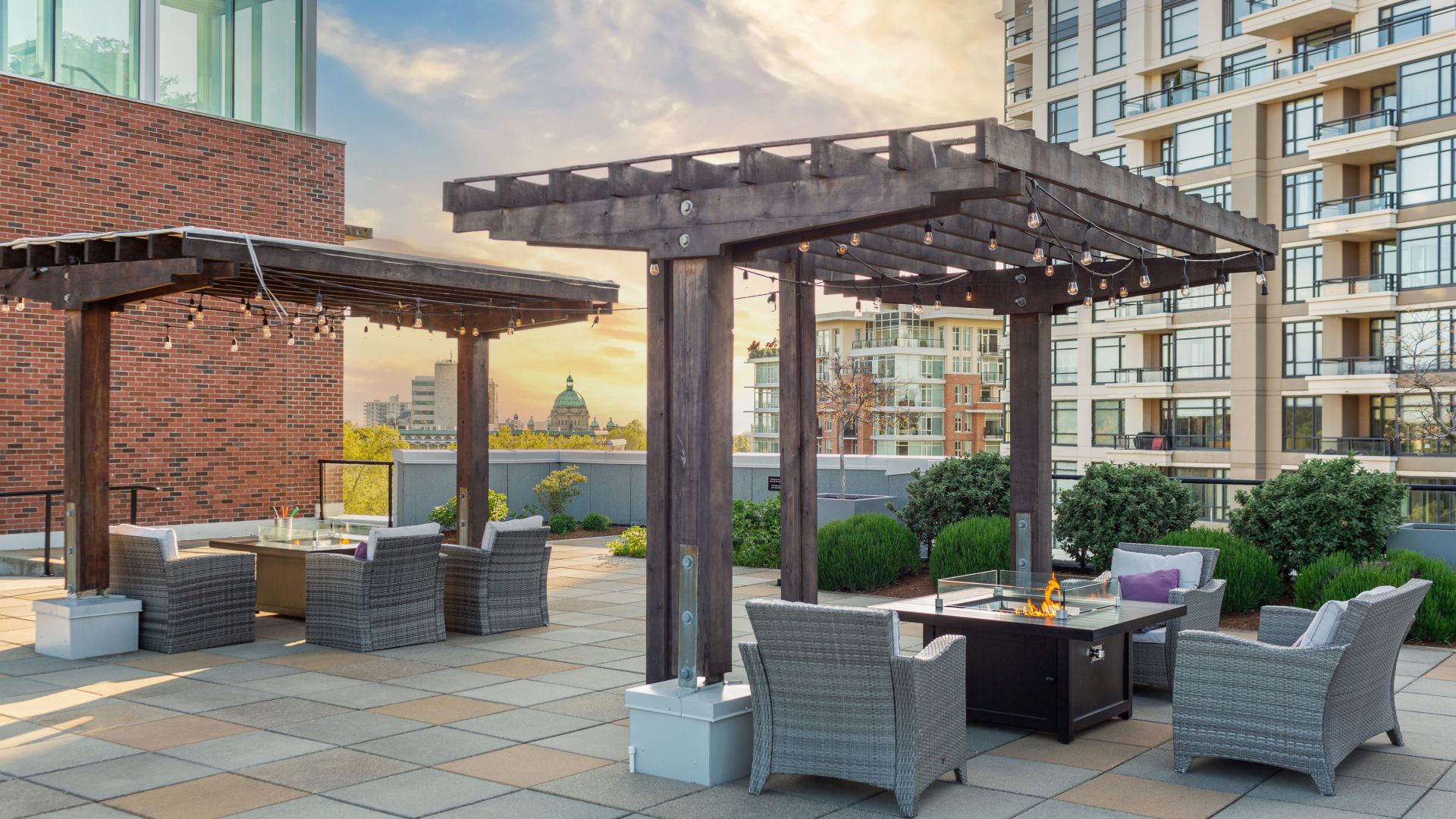 Outdoor rooftop seating at The Parkside Hotel & Spa with multiple chairs, tables with fire pits, and wooden overhangs