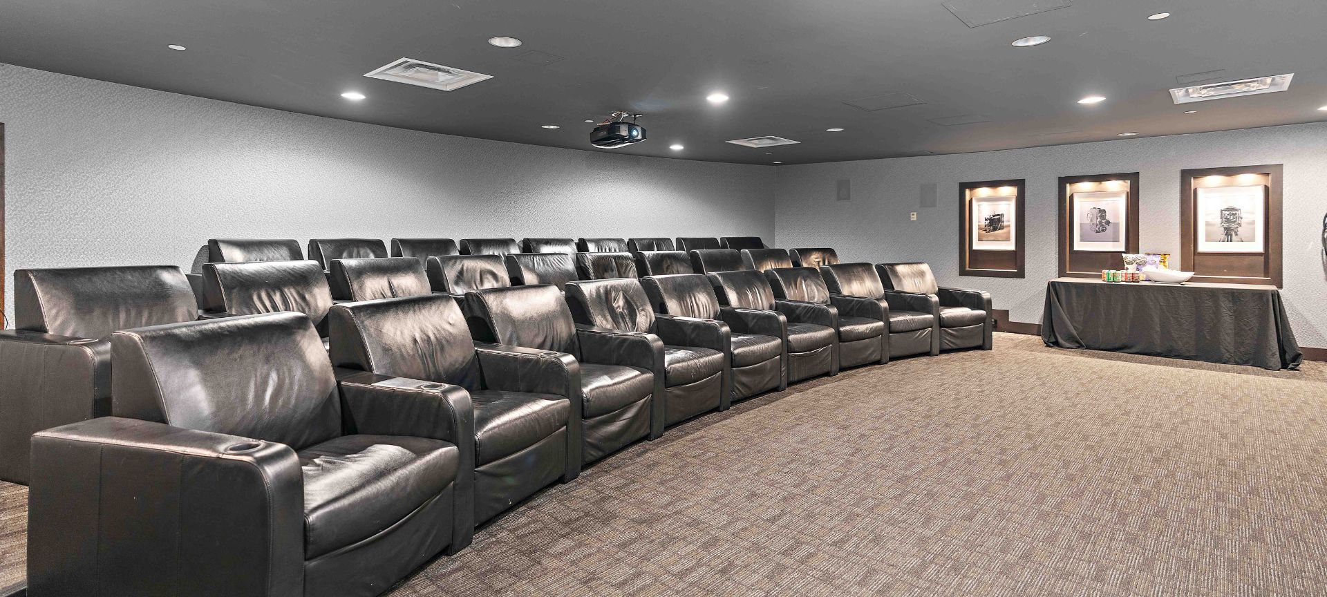A Large Room With Black Leather Couches